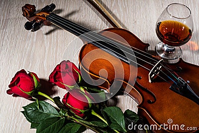 Violin, rose, glass of champagne and music books