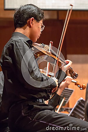 Violonist playing in a classical music concert, China