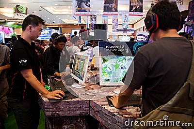 Visitors Playing Video Games at Indo Game Show 2013