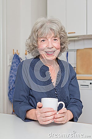 Vivacious senior woman with mug