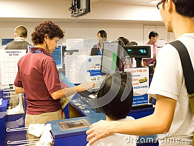 Volunteer with visitors at Cashier counter.