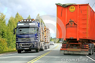 Volvo FH16 Logging Truck and a Trailer Truck on the Road