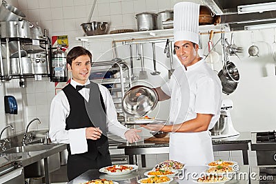 Waiter Taking Customer s Food From Chef