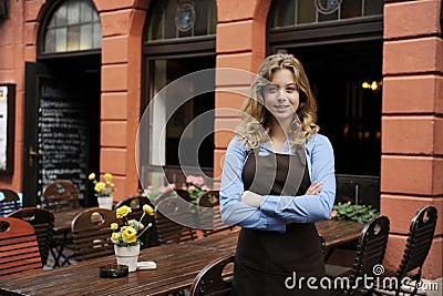 Waitress in front of restaurant