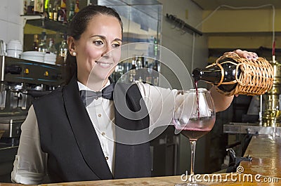 Waitress serving red wine