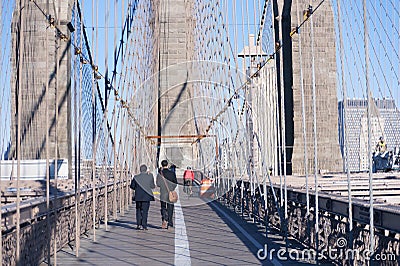 Walking over Brooklyn Bridge New York City