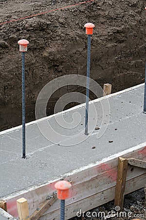 Wall foundation with rebar safety caps