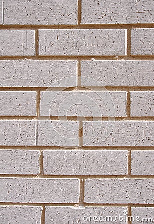 Wall of white bricks with yellow fugue