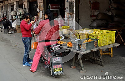 Wan Jia, China: Woman Buying Oranges