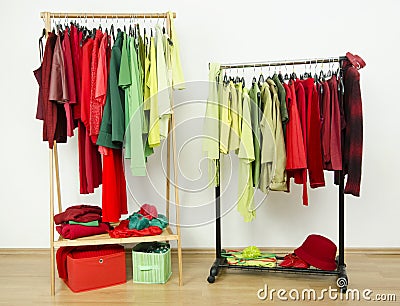 Wardrobe with complementary colors red and green clothes arranged on hangers.