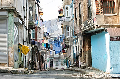 Washed clothes drying on a rope between historical houses of a street
