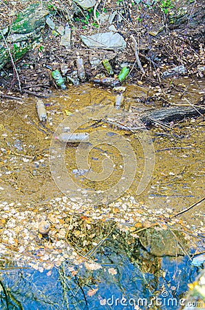 Water pollution of a plastic bottles on a river