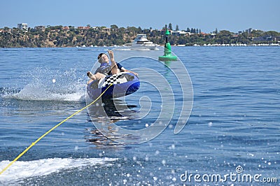 Water tubing skiing teen boy