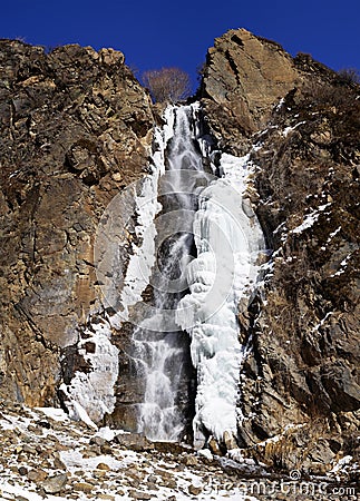 Waterfall, ice, rock and blue sky