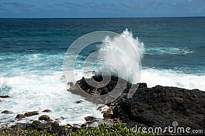 Waves against black lava rock in hawaii