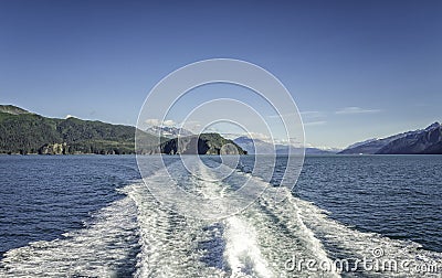 Waves behind cruise ship over Mountains near Seward, Alaska