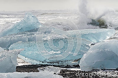 Waves Crash on Blue Icebergs