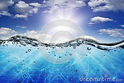 The waves,the water line,on the background of a sunshine in the blue sky