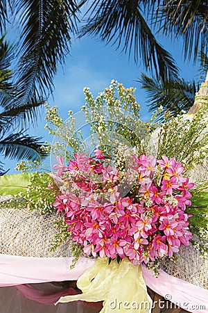 Wedding arch and set up with flowers on tropical beach