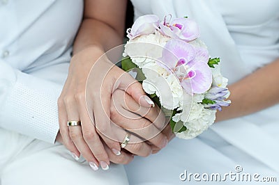 Wedding bouquet with hands and rings