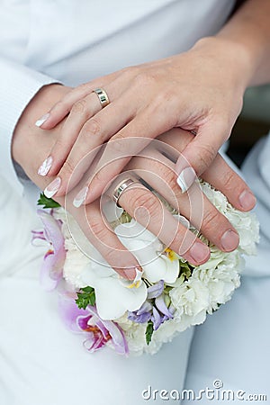 Wedding bouquet with hands and rings
