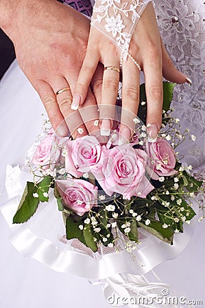 Wedding bouquet tender roses, hands and rings