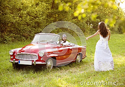 Wedding car with bride and groom