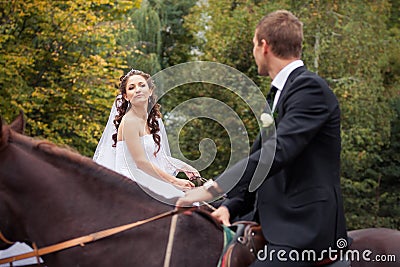 Wedding couple on horses