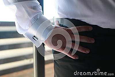 Wedding day groom preparing men wear button a shirt and cufflinks