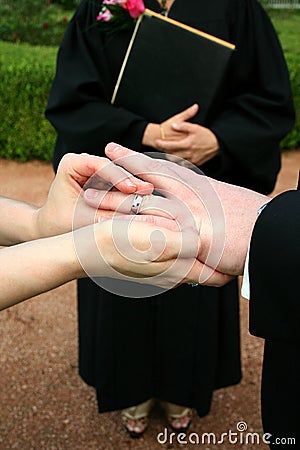 bride and groom exchange rings during their wedding ceremony with ...