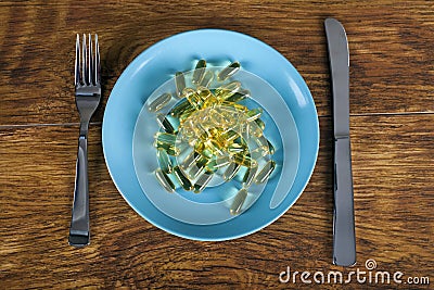 Weight loss concept with diet pills on plate top view