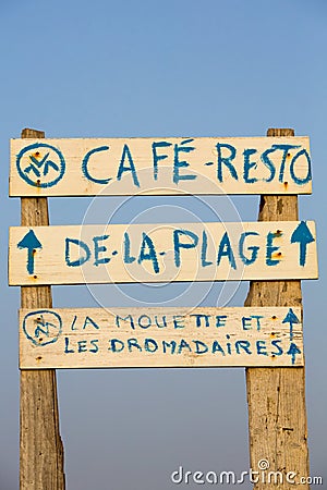 Welcome cafe sign on the beach with blue sky