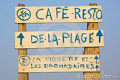 Welcome cafe sign on the beach with blue sky