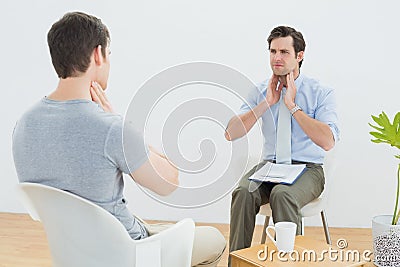 Well dressed male doctor in conversation with patient