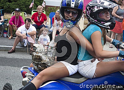 Wellfleet, Massachusetts, USA-July 4, 2014: Two young women riding on a motorcycle in the Wellfleet