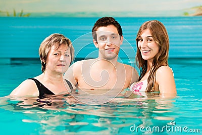Wellness - woman and couple in swimming pool