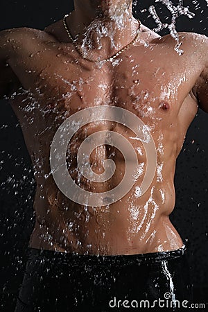 Wet muscle sexy young man torso under the rain
