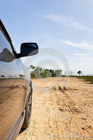 Wheel of a car on dirt road