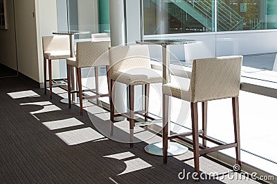 White bar stools and tables