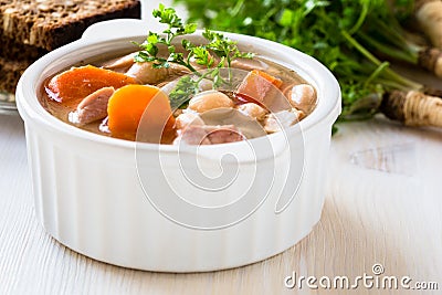 White bean soup made of beans, carrot and ham