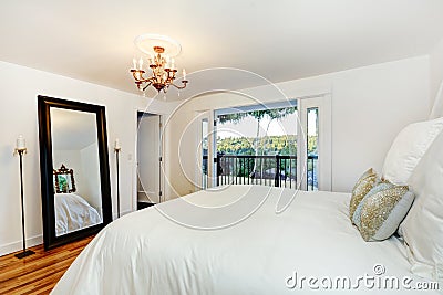 White bedroom interior with walkout deck