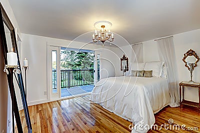 White bedroom interior with walkout deck