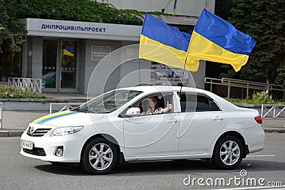 White car with two flags of Ukraine