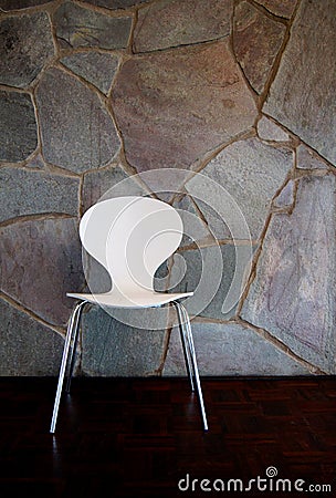 White Chair by stone Wall