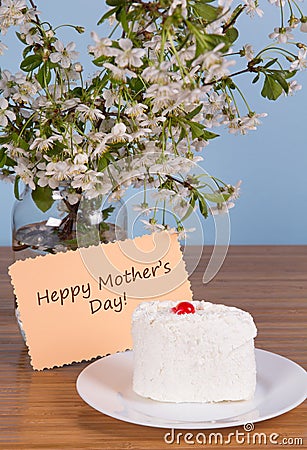 White cherry flowers and a cake on the table