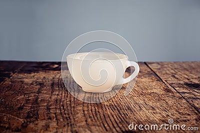 White china coffee cup on a wood table