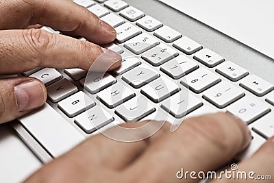 White computer keyboard with hands