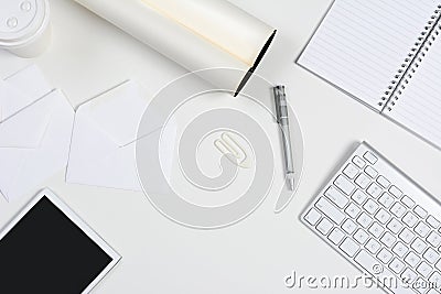 White Desk With Tablet and Keyboard