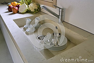 White dishes in the marble sink