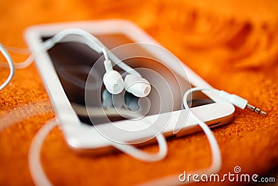 White earphones and tablet pc